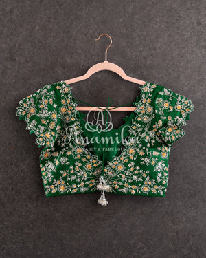 Heavy embroidered Bridal Blouse in Green with intricately designed cutwork neck and sleeves pattern