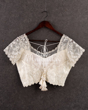 Off white blouse in a stylish net overlay patter with all over self cutdana embroidery