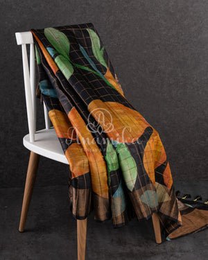 Tussar Saree in black with handpainting floral design, paired with orange ikkat rawsilk blouse
