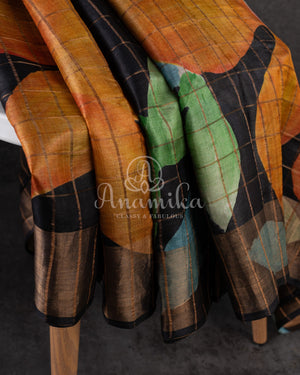 Tussar Saree in black with handpainting floral design, paired with orange ikkat rawsilk blouse