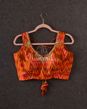 Tussar Saree in black with handpainting floral design, paired with orange ikkat rawsilk blouse