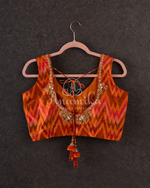 Tussar Saree in black with handpainting floral design, paired with orange ikkat rawsilk blouse