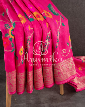 Pink Munga silk saree with all over floral vines and a contrast green handwork blouse