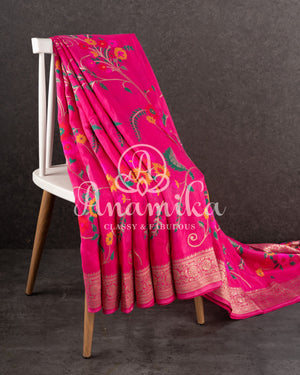 Pink Munga silk saree with all over floral vines and a contrast green handwork blouse