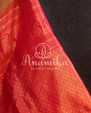 Gadwal pattu saree in a beautiful shade of parrot green and rose pink peach