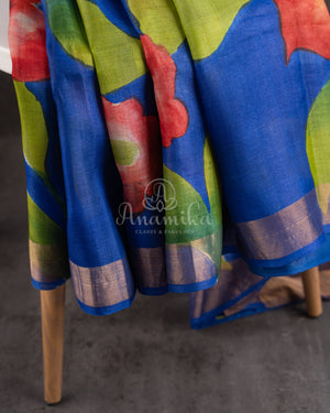 Tussar Saree in dark blue with handpainting floral design, paired with red ikkat rawsilk blouse