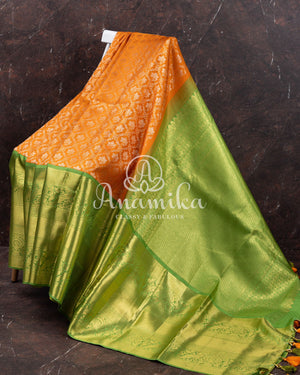 Kanjeevaram saree in a unique shade of light orangish yellow with green blouse