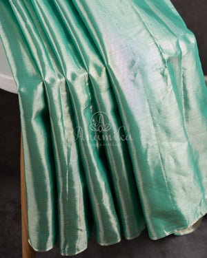 Tissue Kanjeevaram saree in light pastel blue paired with a contrast pink mirror work blouse