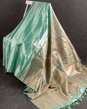 Tissue Kanjeevaram saree in light pastel blue paired with a contrast pink mirror work blouse