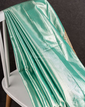 Tissue Kanjeevaram saree in light pastel blue paired with a contrast pink mirror work blouse