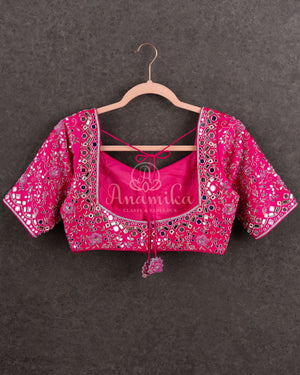 Tissue Kanjeevaram saree in light pastel blue paired with a contrast pink mirror work blouse