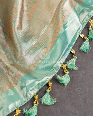 Tissue Kanjeevaram saree in light pastel blue paired with a contrast pink mirror work blouse