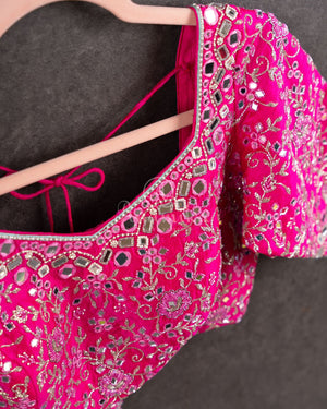 Tissue Kanjeevaram saree in light pastel blue paired with a contrast pink mirror work blouse