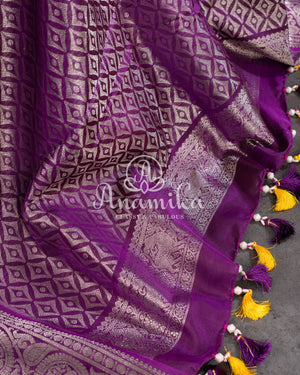 A traditional venkatagiri pattu saree in festive colors of yellow and purple