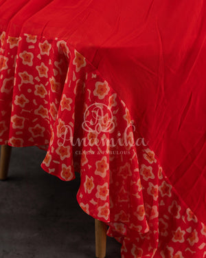 Red Floral Georgette ruffle saree with a stylish sleeveless blouse