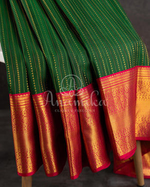 Dark Green Kanchipuram saree with contrast pink gold zari border