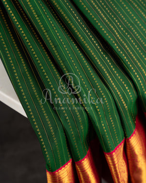 Dark Green Kanchipuram saree with contrast pink gold zari border