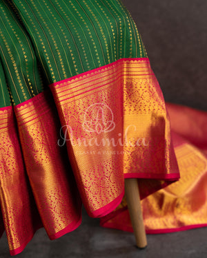 Dark Green Kanchipuram saree with contrast pink gold zari border