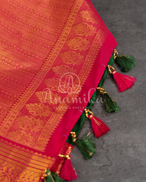 Dark Green Kanchipuram saree with contrast pink gold zari border