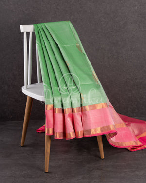 Pastel green soft silk kanchipuram saree with contrast pink border and blouse