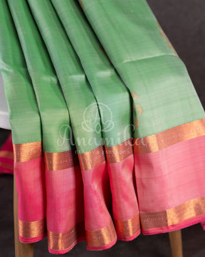 Pastel green soft silk kanchipuram saree with contrast pink border and blouse
