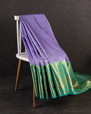 Lavender Kanchipattu saree with a contrast sky blue border and blouse