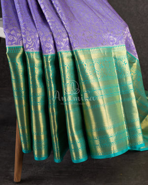 Lavender Kanchipattu saree with a contrast sky blue border and blouse