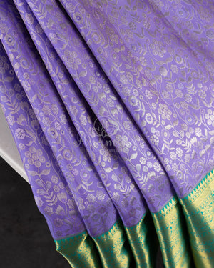 Lavender Kanchipattu saree with a contrast sky blue border and blouse