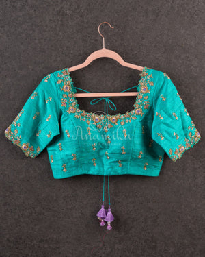 Lavender Kanchipattu saree with a contrast sky blue border and blouse