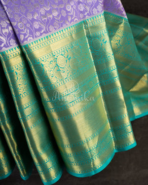 Lavender Kanchipattu saree with a contrast sky blue border and blouse
