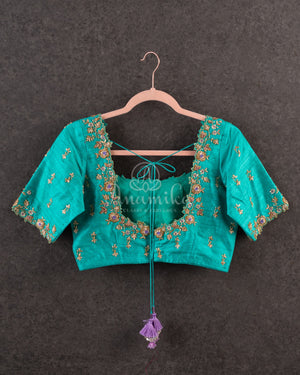 Lavender Kanchipattu saree with a contrast sky blue border and blouse