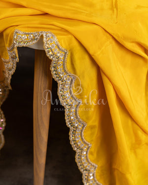 Yellow pure crepe saree with handwork scallop border