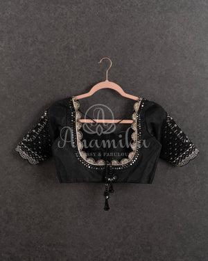 Black Pleated saree with an embroidered border and blouse