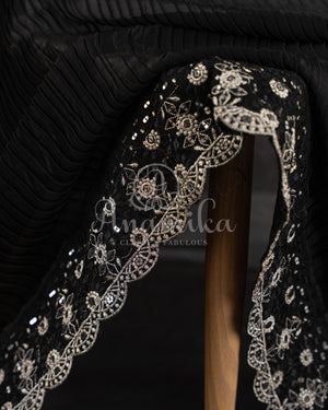 Black Pleated saree with an embroidered border and blouse