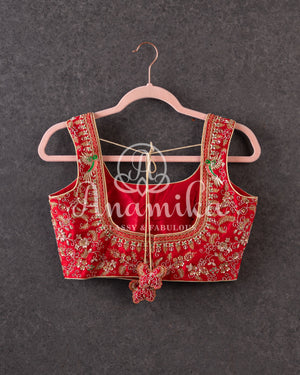 Red sleeveless blouse with all over gold work