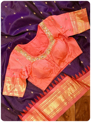 A checkered Gadwal Pattu saree in purple and peach combo