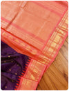A checkered Gadwal Pattu saree in purple and peach combo