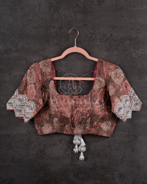 Crushed Tissue Saree in Orange paired with a floral work blouse