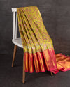 A tissue kanjeevaram saree in parrot green with pink border