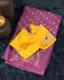 Organza silk saree in lavender with a contrast yellow handwork blouse