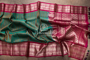 Dark Green Gadwal Pattu saree with a pink border