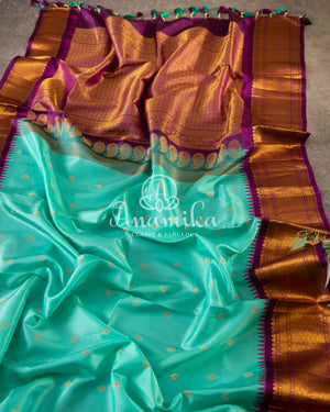 Teal Blue Gadwal Silk saree with contrast dark purple border