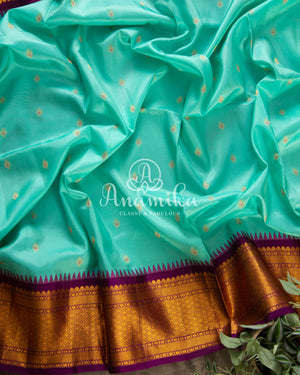 Teal Blue Gadwal Silk saree with contrast dark purple border