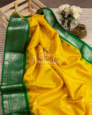 Lovely Yellow Gadwal pattu saree with contrast dark green border