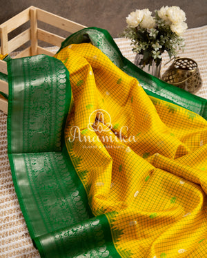 Lovely Yellow Gadwal pattu saree with contrast dark green border