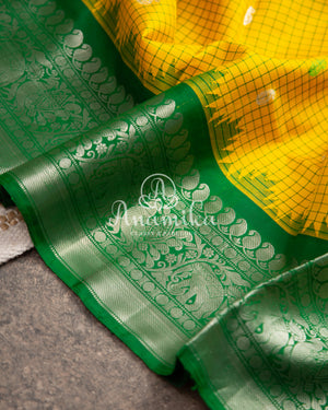 Lovely Yellow Gadwal pattu saree with contrast dark green border