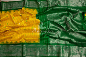 Lovely Yellow Gadwal pattu saree with contrast dark green border