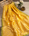 Yellow Banarasi saree with parrot green maggam work border