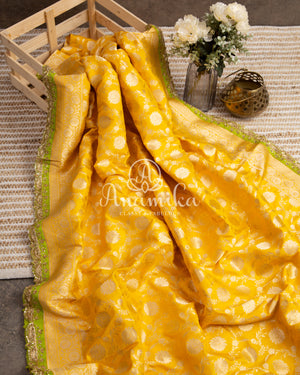 Yellow Banarasi saree with parrot green maggam work border