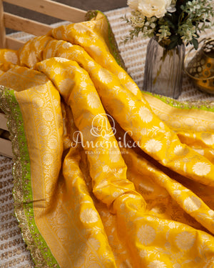 Yellow Banarasi saree with parrot green maggam work border